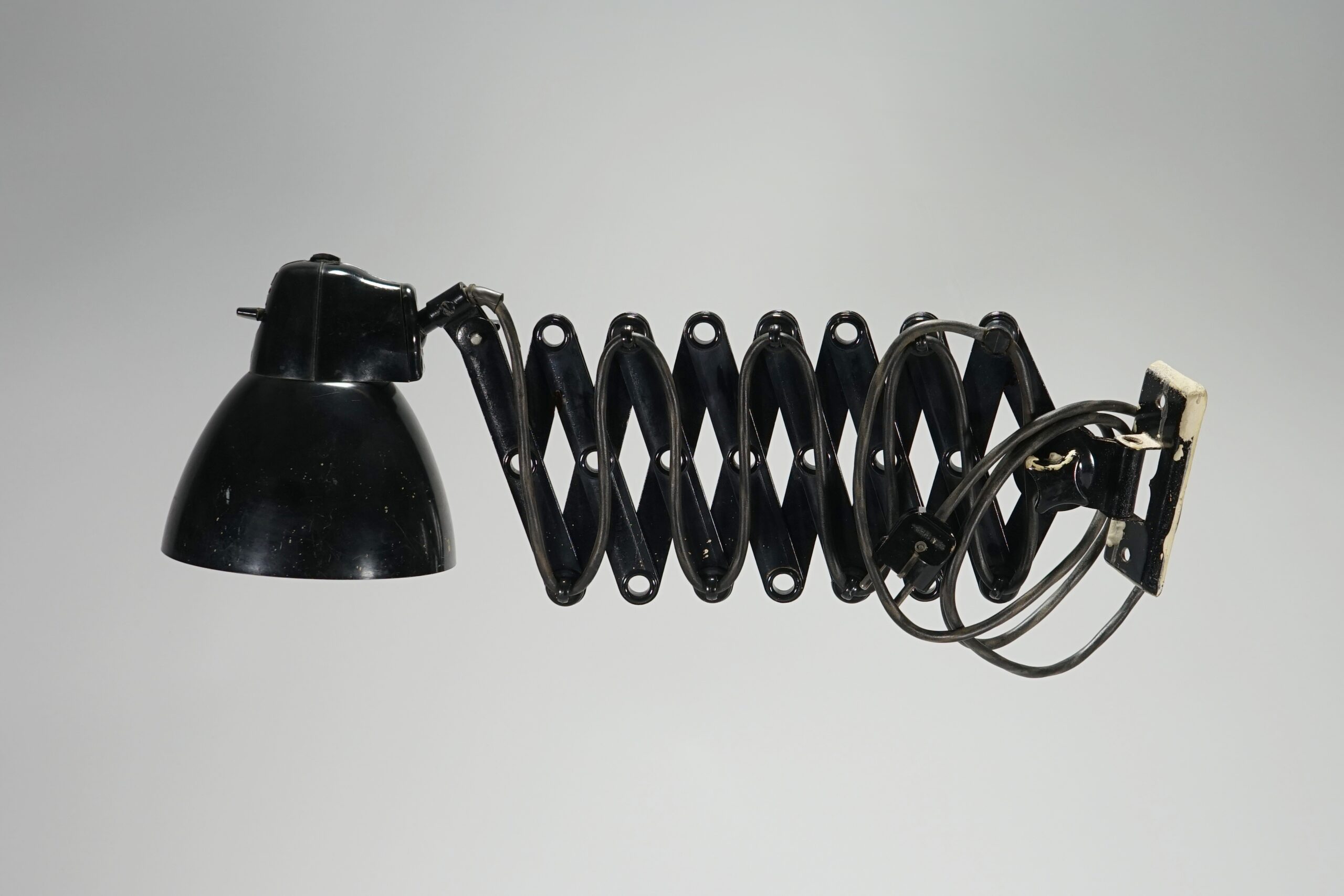 Schwarze Lampe, die man ähnlich einer Ziehharmonika horizontal in die Länge ziehen kann